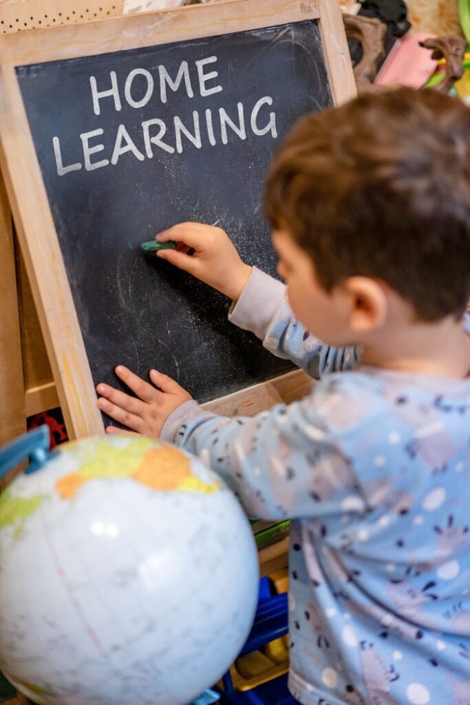 A child exploring home education using a blackboard and chalk, fostering early learning.