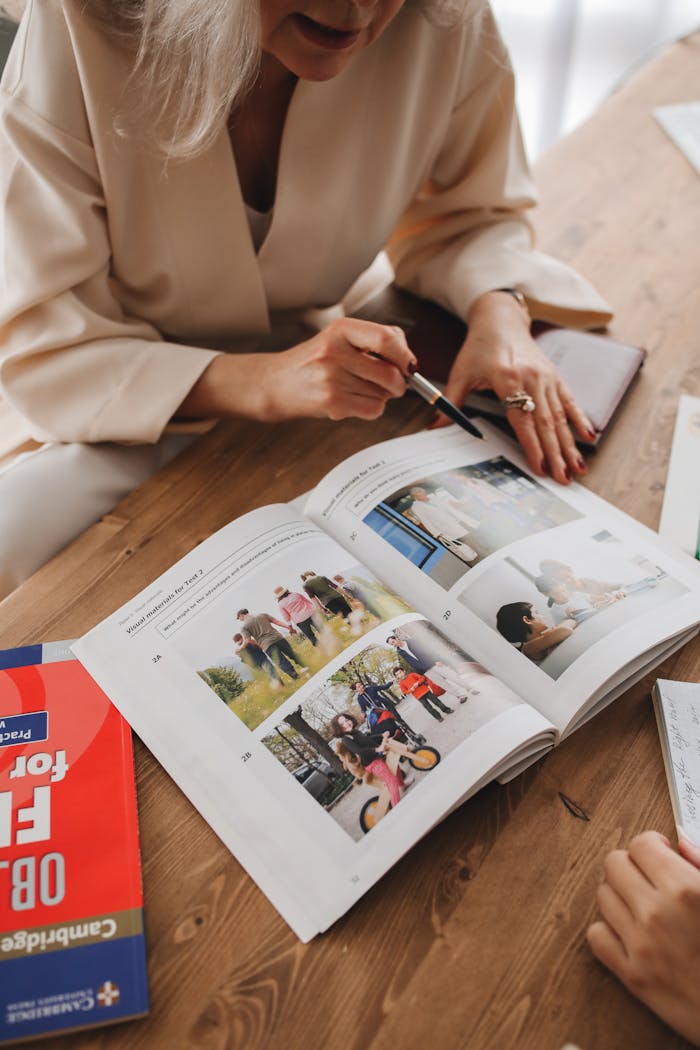 Adults engaged in learning session with an open reference book and educational material.